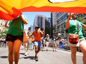 Participants walk in the Toronto Pride Parade, in Toronto, Sunday June 25, 2023.