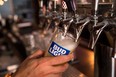 A bartender pours a Bud Light from a tap, July 26, 2018 in New York City.