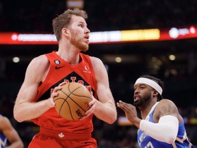Jakob Poeltl of the Raptors dribbles against Wesley Matthews of the Bucks during first half NBA action at Scotiabank Arena in Toronto, April 9, 2023.