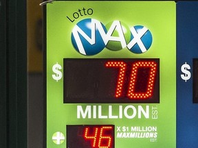 A Lotto Max sign is seen in a window in downtown Toronto, May 6, 2022.