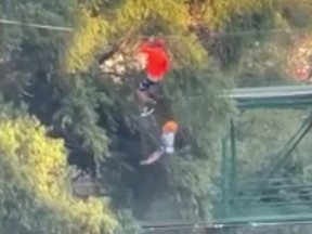 A screenshot of a submitted video showing themoment a six-year-old boy falls from a zipline into a lake at an amusement part in Mexico. Luckily, the boy was uninjured.