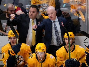Nashville Predators coach John Hynes, top right, and assistant coach Dan Lambert gesture to players during the third period of the team's NHL hockey game against the Colorado Avalanche on Friday, April 14, 2023, in Nashville, Tenn.
