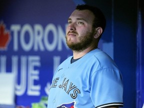 Toronto Blue Jays catcher Alejandro Kirk looks on against the Milwaukee Brewers from the dugout during the seventh inning at Rogers Centre.