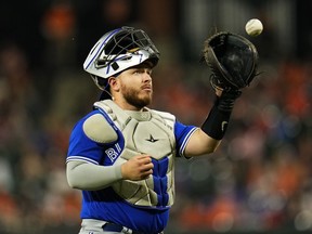Toronto Blue Jays catcher Alejandro Kirk gets a new ball after a play during the eighth inning of a baseball game between the Baltimore Orioles and the Toronto Blue Jays, Wednesday, June 14, 2023, in Baltimore. Kirk has returned from the Toronto Blue Jays 10-day injured list.