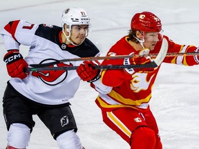Yegor Sharangovich battles against Tyler Toffoli during NHL hockey at the Scotiabank Saddledome in Calgary on Saturday, November 5, 2022.