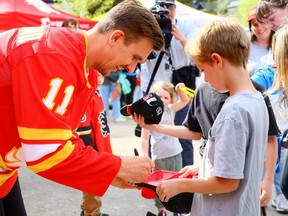 Mikael Backlund signs autographs as the Calgary Flames Foundation announced a significant donation to five recreational spaces in Calgary in partnership with the Parks Foundation Calgary on Thursday, May 11, 2023.