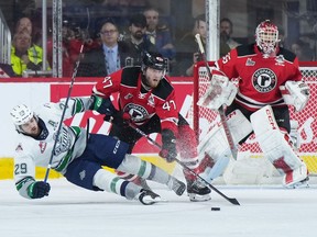 The Quebec Remparts' Charle Truchon (47) checks Seattle Thunderbirds' Jared Davidson (29) as Quebec goalie William Rousseau watches during the Memorial Cup final in Kamloops, B.C., on Sunday, June 4, 2023.