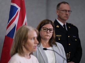 Manitoba Premier Heather Stefanson, back centre, and RCMP Supt. Rob Lasson, back right, listen as Lanette Siragusa, CEO of Shared Health, speaks about the Carberry bus crash during a news conference at RCMP headquarters, in Winnipeg, on Monday, June 19, 2023. Stefanson says the province will bring in experts if necessary as part of a review to ensure safety at an intersection where 15 seniors were killed in a crash.