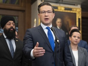 Flanked by Conservative Finance and Middle Class Prosperity critic Jasraj Singh Hallan and Conservative deputy leader Melissa Lantsman and other members of Parliament, Conservative leader Pierre Poilievre speaks with reporters in the Foyer of the House of Commons, Monday, June 5, 2023 in Ottawa.