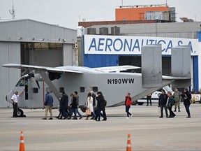 Members of human rights organizations, relatives and victims of the dictatorship, are given access to the Short SC-7 Skyvan aircraft used in the last Argentine military dictatorship (1976-1983) by the Naval Prefecture under registration PA-51, as it sits on the tarmac upon landing at Jorge Newbery International Airport in Buenos Aires, on June 24, 2023.