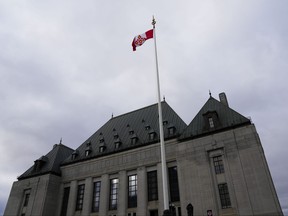The flag of the Supreme Court of Canada flies on the east flag pole