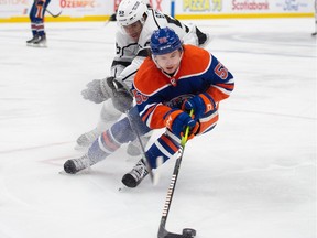 Kailer Yamamoto (56) of the Edmonton Oilers, skates into the corner with Quinton Byfield of the Los Angles Kings at Rogers Place in Edmonton on March 30, 2023. Photo by Shaughn Butts-Postmedia