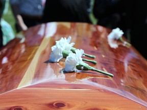 Boutonnieres left atop a casket.