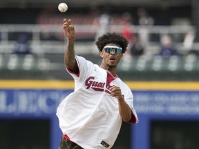 Cleveland Browns cornerback Greg Newsome II throws out a ceremonial first pitch before a baseball game between the Chicago White Sox and the Cleveland Guardians, Monday, May 22, 2023, in Cleveland.