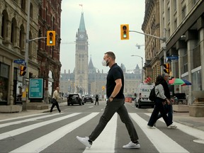 Hazy skies and wildfire smoke continued to fill the air in Ottawa on Wednesday, June 7, 2023, prompting many outside to don face masks and even N95s to stave off the air pollution as much as possible.