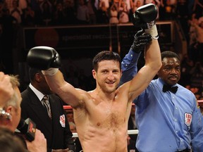 Carl Froch (left) celebrates winning the IBF super-middleweight title with victory over Lucian Bute in 2012.