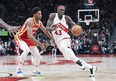 Toronto Raptors forward Pascal Siakam controls the ball as Atlanta Hawks forward De'Andre Hunter tries to defend.