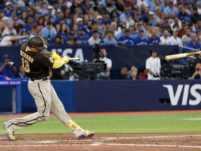 Manny Machado of the San Diego Padres breaks his bat as he hits a two-run single in the fifth inning against the Toronto Blue Jays at Rogers Centre on Wednesday, July 19, 2023, in Toronto.