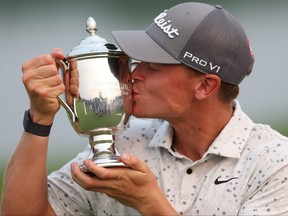 Vincent Norrman of Sweden celebrates with the trophy after putting in to win on the 18th hole during the sudden death playoff against Nathan Kimsey of England during the final round of the Barbasol Championship at Keene Trace Golf Club on Sunday, July 16, 2023 in Nicholasville, Ky.
