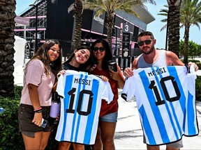 Fans of Argentine soccer player Lionel Messi pose for a photo at the DRV PNK Stadium in Fort Lauderdale, Fla., on Tuesday, July 11, 2023, ahead of Messi's MLS debut this month with Inter Miami.