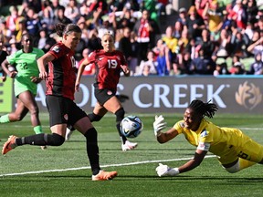 Nigeria's goalkeeper #16 Chiamaka Nnadozie (R) clears after saving a penalty kick by Canada's forward #12 Christine Sinclair during the Australia and New Zealand 2023 Women's World Cup Group B football match between Nigeria and Canada at Melbourne Rectangular Stadium, also known as AAMI Park, in Melbourne on July 21, 2023.