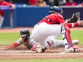 Red Sox baserunner Justin Turner stands safe at home against Blue Jays' Danny Jansen during fifth inning MLB action at the Rogers Center in Toronto on Saturday, July 1, 2023.