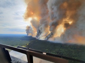 Smoke rises from a wildfire in the Donnie Creek Complex south of Fort Nelson on May 27, 2023.