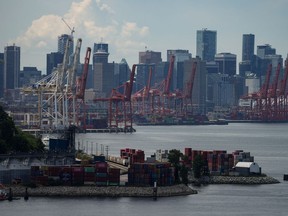 Gantry cranes sit idle above stacks of cargo containers at port during a strike by International Longshore and Warehouse Union Canada workers in the province, in Vancouver, on Wednesday, July 12, 2023.