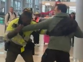A Canadian tourist was captured on video throwing punches at a cop at a Colombian airport.