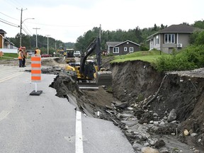 Crews begin repairs to a washed-out section of Highway 170 in Riviere-Eternite, Que., Sunday, July 2, 2023.