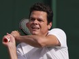 Canada's Milos Raonic returns to Tommy Paul of the U.S. in a men's singles match on day four of the Wimbledon tennis championships in London on July 6, 2023.
