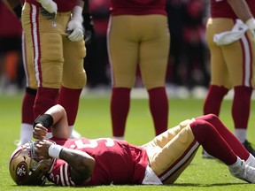 QB Trey Lance of the San Francisco 49ers lies on the field with a broken right ankle yesterday at Levi's Stadium in Santa Clara, Calif.