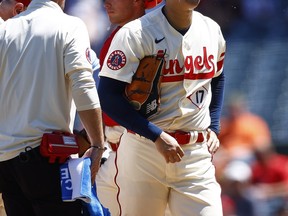 Shohei Ohtani #17 of the Los Angeles Angels leaves the game against the Cincinnati Reds in the second inning during game one of a doubleheader at Angel Stadium of Anaheim on August 23, 2023 in Anaheim, California.