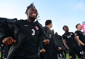 Sam Adekugbe, left, and Richie Laryea, 22, celebrate Canada's victory over the U.S. in the FIFA World Cup Qualifiers in Hamilton in January 2022. Both were disappointed that the coach who'd help get them to the World Cup, John Herdman, had left the national team to coach Toronto FC.