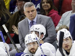 Toronto Maple Leafs coach Sheldon Keefe watches play during the second period of the team's NHL game against the Carolina Hurricanes on March 25, 2023, in Raleigh, N.C.