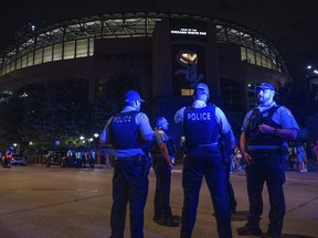 Chicago police officers stand outside Guaranteed Rate Field on Friday, Aug. 25, 2023, in Chicago. Police are investigating a shooting at the White Sox's baseball game at the stadium Friday night. Police said the investigation is ongoing.