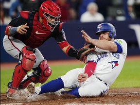 Washington Nationals catcher Keibert Ruiz, left, tags out the Toronto Blue Jays' Alejandro Kirk during eighth inning MLB action in Toronto on Tuesday, Aug. 29, 2023.