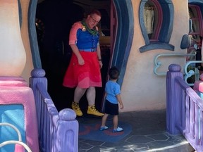 A male Disney World employee wearing a red dress is seen at the theme park in an image shared to social media last week.