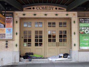 Homeless people sleep in the doorway of the American Conservatory Theater on May 11, 2023 in San Francisco, California.