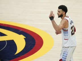 Denver Nuggets guard Jamal Murray gestures during the second half of Game 5 of basketball's NBA Finals against the Miami Heat, Monday, June 12, 2023, in Denver. Murray will not suit up for Canada in the upcoming FIBA World Cup, Canada Basketball announced on Wednesday.THE CANADIAN PRESS/AP/Jack Dempsey