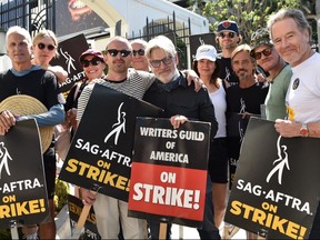 Actors (from left to right) Patrick Fabian, Rhea Seehorn, Norma Maldonado, Aaron Paul, writer Peter Gould, Betsy Brandt, Matt Jones, Charles Baker, Jesse Plemons and Bryan Cranston join members of the Screen Actors Guild (SAG-AFTRA) and WGA on the picket line in front of Sony Studios in Culver City, Calif., on Aug. 29, 2023.