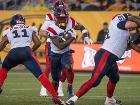 Montreal Alouettes running back Jeshrun Antwi (20) runs for a gain during first half CFL football game action against the Hamilton Tiger Cats in Hamilton, Ont. on Friday, June 23, 2023.