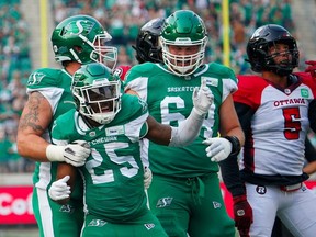 Saskatchewan Roughriders running back Jamal Morrow (25) celebrates with teammates after scoring a touchdown against Ottawa Redblacks during the first half of CFL football action in Regina on Sunday, August 6, 2023.