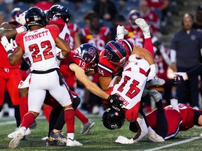 The Alouettes' Alexandre Gagné (34) upends Redblacks kick returner Tobias Harris (41) during first-half action on Saturday night.