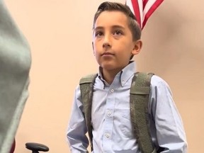 Boy wearing dress shirt and backpack.