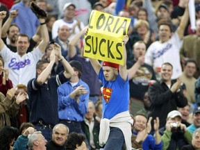 An Expos fan shows his displeasure with then-owner Jeffrey Loria as he walks on top of a dugout during the home opener at Olympic Stadium in 2002.