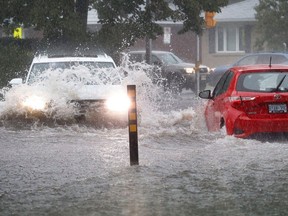 Residence of Ottawa tried to get home in a rain storm that left flooding all over the city Thursday afternoon. Water over a bumper on Sanderson Drive.