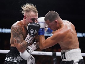 Jake Paul, left, and Nate Diaz trade punches during the third round of their fight at the American Airlines Center on August 5, 2023 in Dallas.