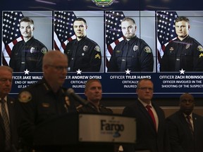 Official portraits of Fargo, N.D., police officers involved in a shooting are displayed during a news conference, Saturday, July 15, 2023, at Fargo City Hall.