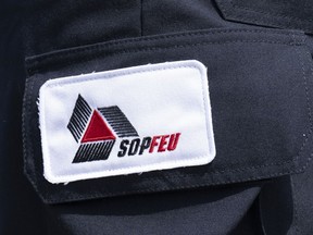 A SOPFEU patch is seen on the leg of an employee near Lebel-sur-Quevillon, Que., Wednesday, July 5, 2023.